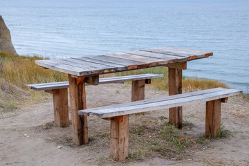 table and benches by the sea. A place to sit and relax.