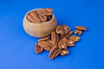 Pekan nut close-up on a classic blue background.