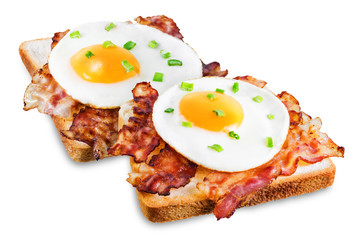 Fried egg fried bacon sandwich on a white isolated background