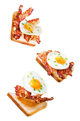 Fried egg fried bacon sandwich on a white isolated background