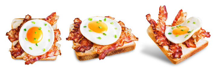 Fried egg fried bacon sandwich on a white isolated background
