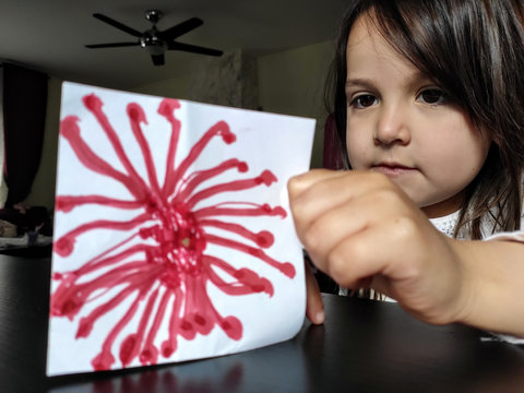 Four year old girl with a coronavirus hand made drawing