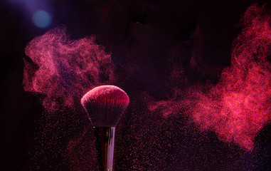 Colorful explosion on makeup brushes on a black background - 336206571