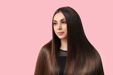 Young woman with beautiful straight hair on color background