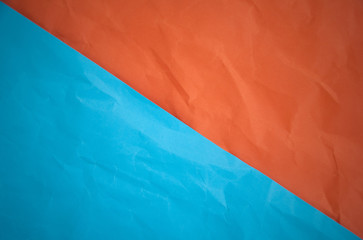 Background of half orange and half blue paper texture.Orange blue paper pattern background. Abstract grunge background.