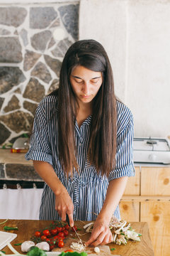 Woman preparing ingredients for Mediterranean lunch