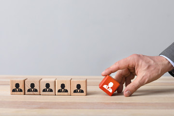 Man removing cube with drawn worker from table. Concept of dismissal