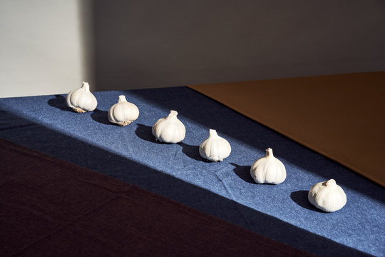 Row of garlic on table