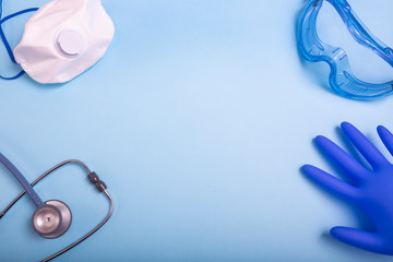 Coronavirus personal protective equipment (PPE)  concept. Medical latex gloves, protective goggles and ffp2 respirator.