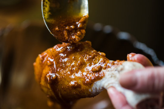 Photo Of A Person Marinating Raw Chicken Legs, Close-up