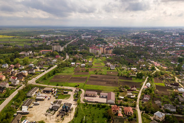 Aerial landscape of small town or village with rows of residential homes and green trees.