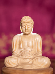 Statuette of Gautama Buddha in light marble in a prayer position