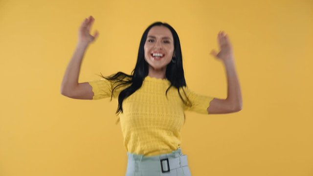 Existed woman showing yes gesture isolated on yellow