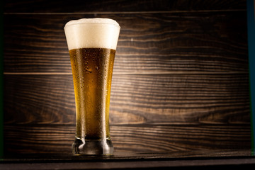 glass of beer on wooden table