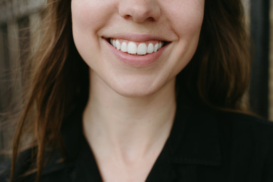 close up of a woman smiling with teeth