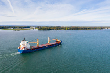 Naklejka premium Cargo ship near the Port of Montreal on the St-Lawrence River