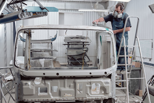 Auto Service Specialist Removing Car Paint