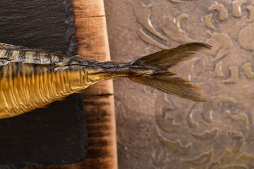 Tail of smoked mackerel on a background