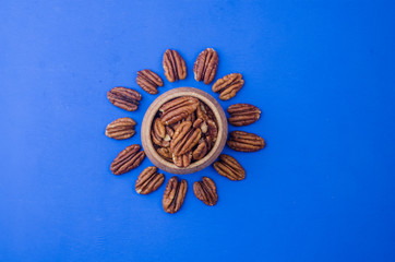Pekan nut close-up on a classic blue background.