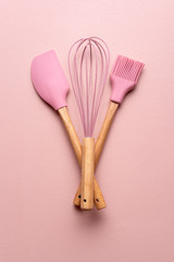 Baking tools on a pink table. Kitchenware flat lay