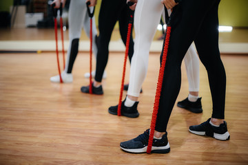 Fototapeta na wymiar Athletic young girls are engaged in fitness and aerobics in a group class. Fitness, healthy lifestyle