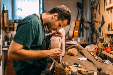 Guitar maker working in a beautiful spanish guitar