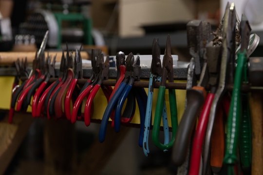 Various pliers hanging on rack