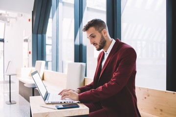 Man working with laptop in coworking space