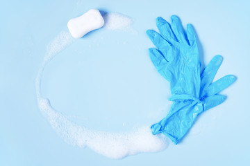 Background with soap and rubber gloves accessories on blue, washing and disinfection concept