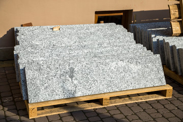 Piles of granite marble slabs.  Stone sheets for decorative construction. - obrazy, fototapety, plakaty