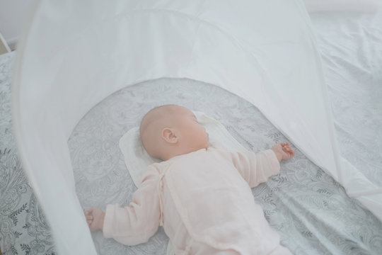 Baby sleeping at home in summer