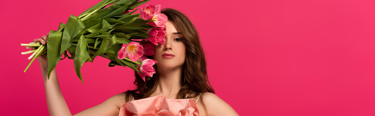 panoramic shot of girl holding bouquet of spring tulip flowers isolated on pink