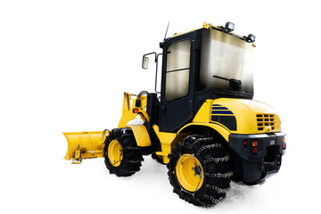 Yellow bulldozer in pile of snow