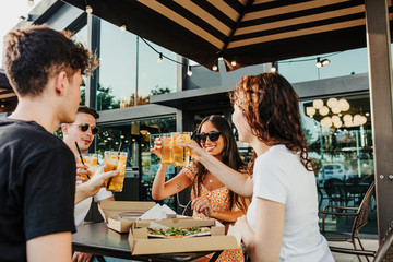 Meeting of friends in a bar celebrating the beginning of summer.