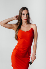 Fototapeta premium A beautiful young makeup artist poses with tassels on a white background in the Studio. Makeup