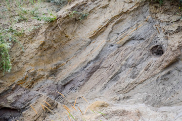 sedimentary layers of the rock in the sand scree. sand, pebbles and shells in sedimentary rocks.