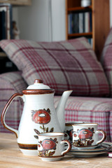 Fototapeta na wymiar Coffee pot and cups on a lounge table