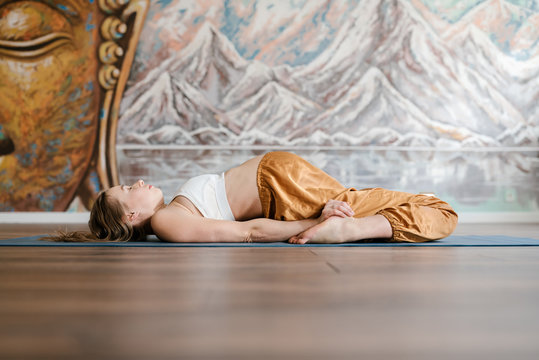 Pregnant lying in relaxed supta virasana pose