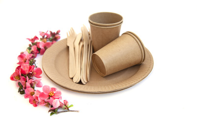 disposable eco tableware from paper cardboard spoon fork knife on a white background, view from the top.