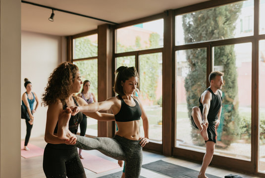 Scene of a group of people practicing yoga in class.