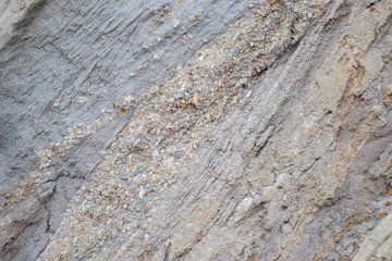 sedimentary layers of the rock in the sand scree. sand, pebbles and shells in sedimentary rocks.