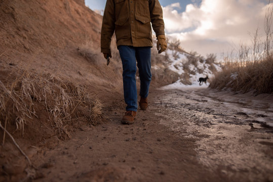 Cowboy walking through Mud and Snow