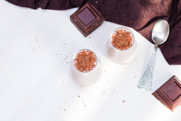 Chocolate chia pudding in glass. Healthy organic snack with omega 3. Overhead, top view, flat lay, copy space.