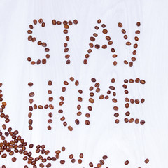 Coffee beans on white wooden background, stay at home concept.