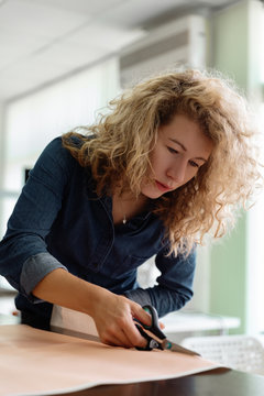 Designer cutting out paper pattern