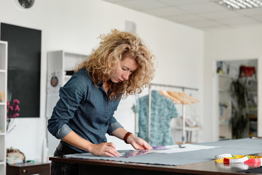 Woman transferring patterns on fabric