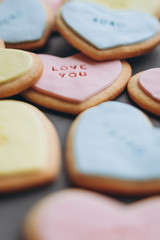 Valentine's Day presents: Heart-shaped cookies with colorful glaze and themed lettering for all lovers