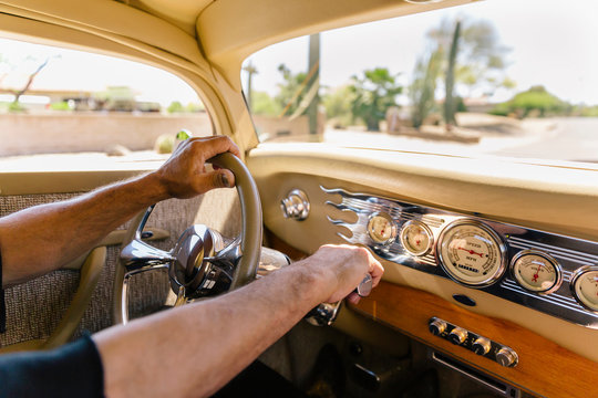 Hands on Steering Wheel in Car with Dashboard