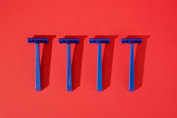 Blue Disposable Razors on Red
