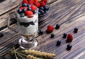 Fototapeta na wymiar Muesli with berries and chia seeds on a wooden table